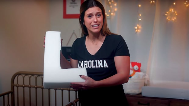 A South Carolina fan holds a baby pillow shaped like the letter L.